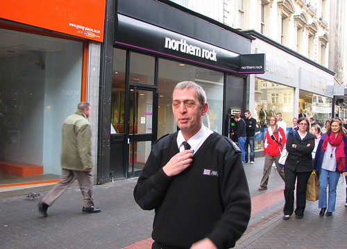 A security guard detains a street photographer