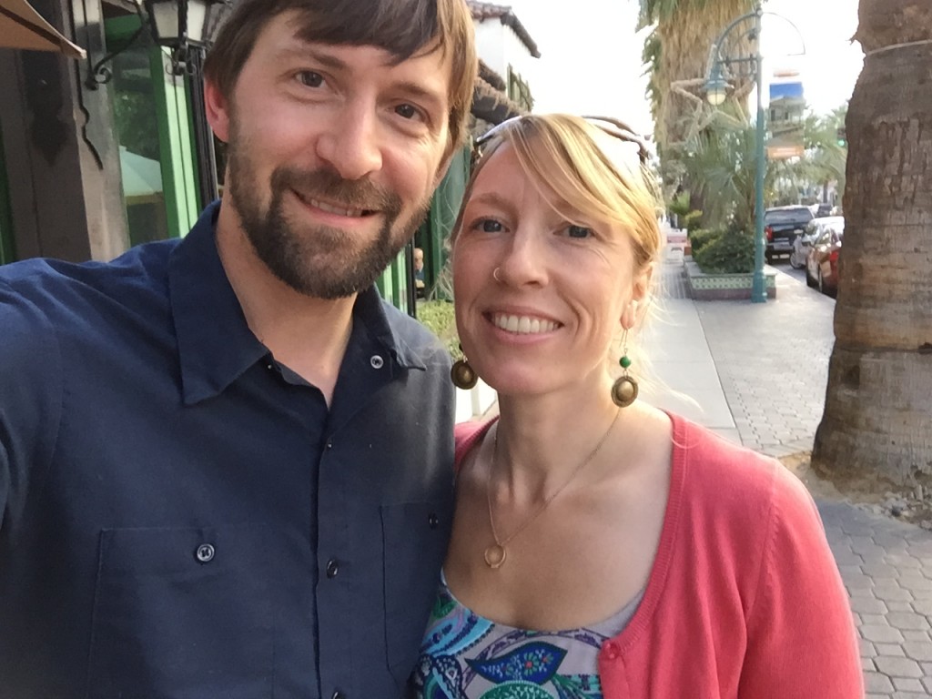 Selfie of Jeff and Andrea on a palm tree lined street in downtown Palm Springs.