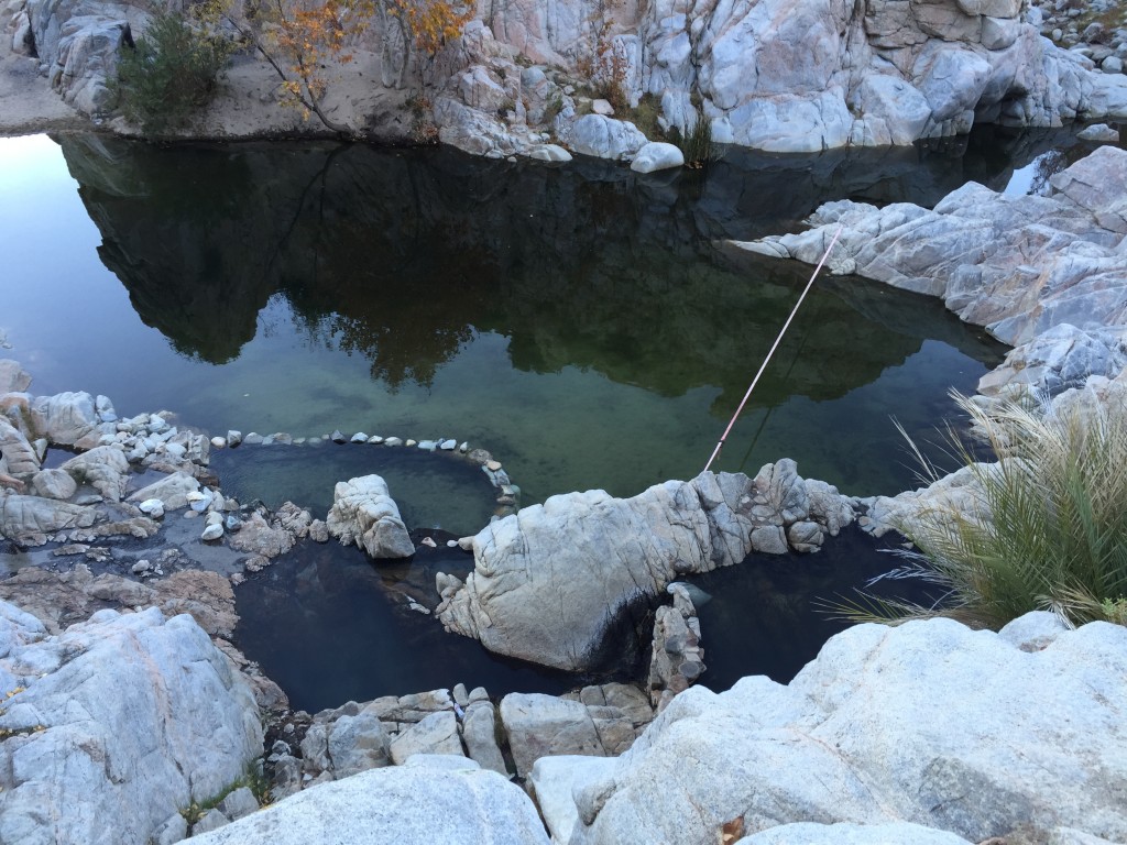 Three of the hot springs pools are visible from a high angle looking down. The slack line across the creek is also visible.