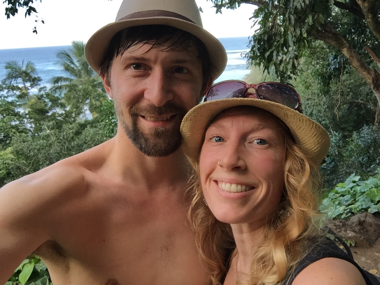 Selfie of Jeff and Andrea with ocean and palm trees in the background.