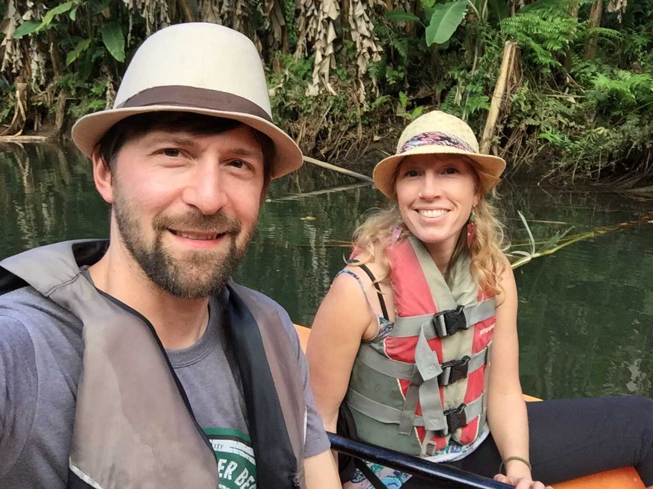 Jeff and Andrea in kayaks along a river in Kauai