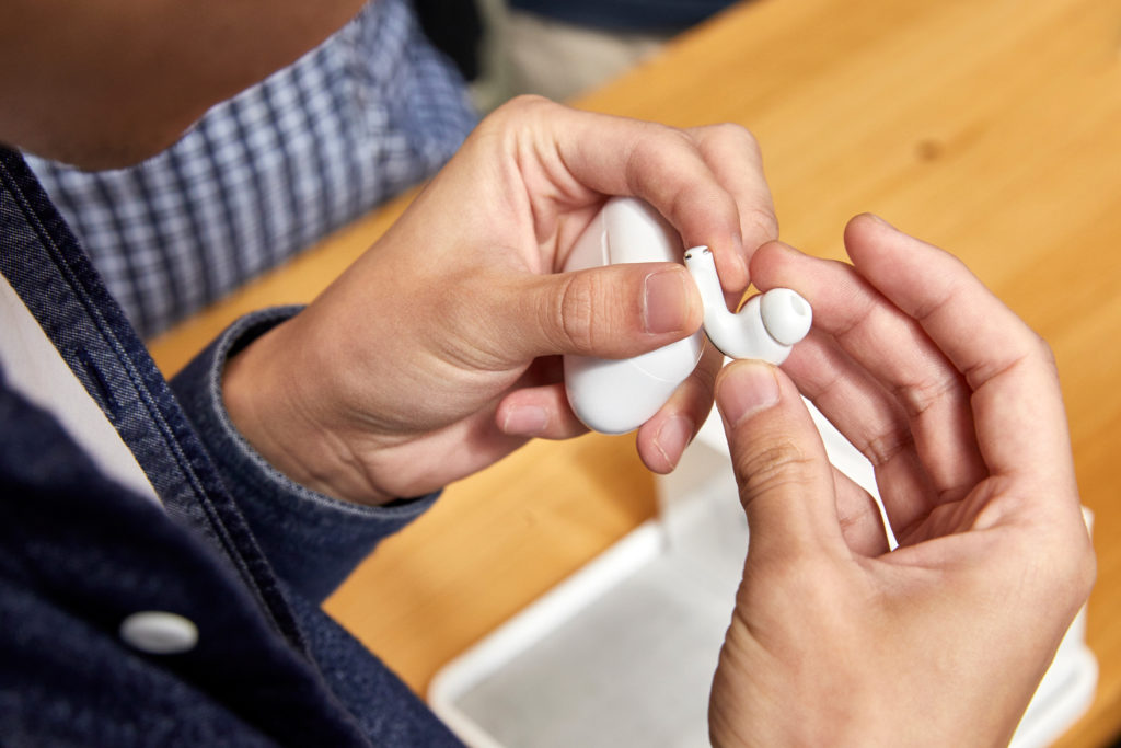 Apple AirPods Pro in the hands of a customer.