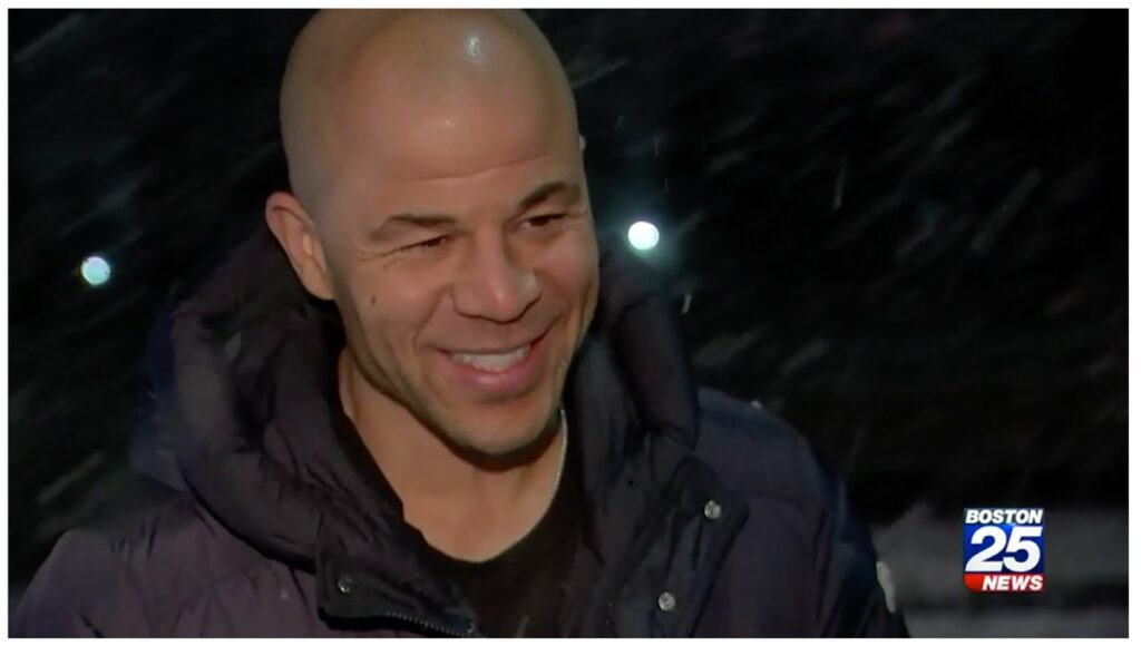 Jerome Iginla talking to news reporter about the weather.